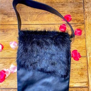 Black leather bag, crossbody or shoulder hold. Just enough fur. Magnetic close.